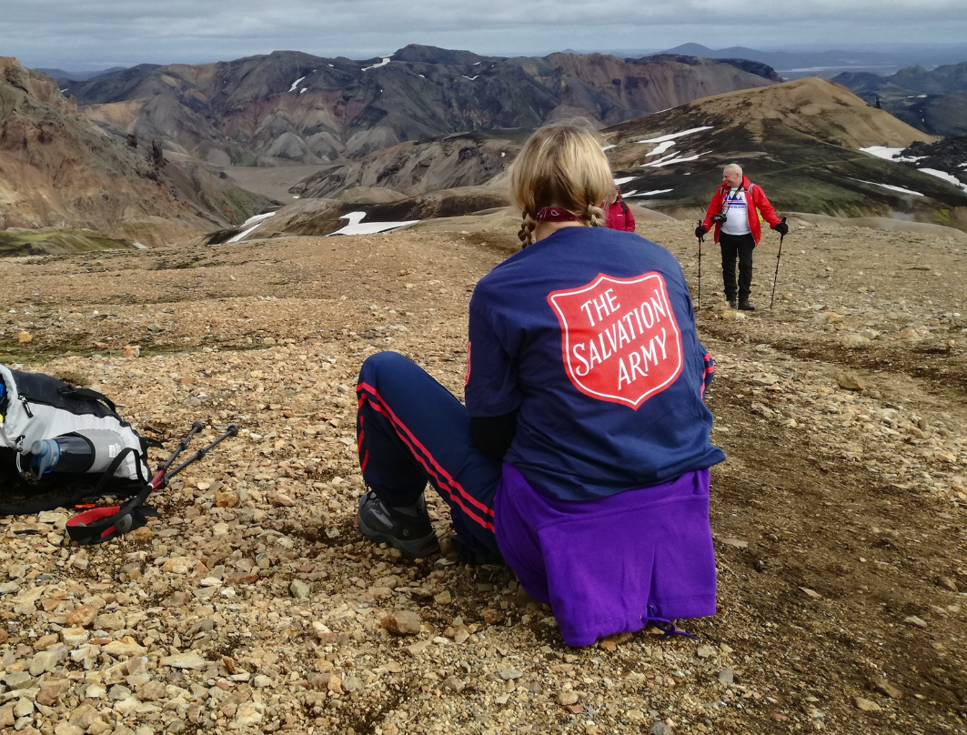 fundraiser in salvation army t-shirt at mountain top