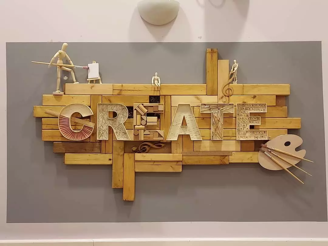 A wooden sign that reads create