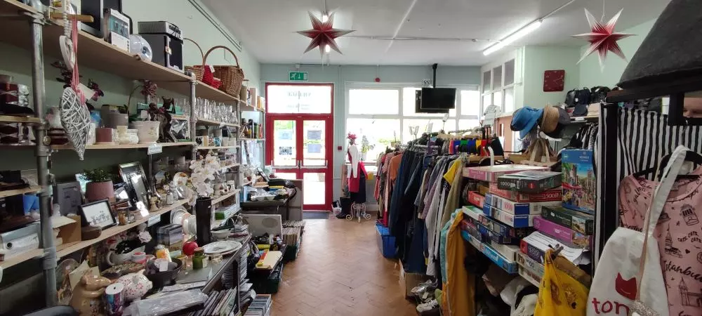 Nunhead Salvation Army shop looking out the front door, showing the wide range of items they have