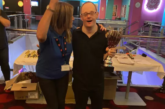 Michael receives a trophy after winning tenpin bowling league