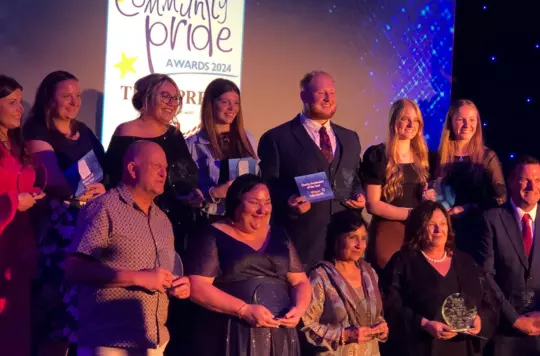 Charlie on stage with others with his award 