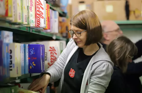 Stock image of Salvation Army volunteer in a foodbank 